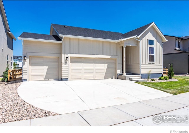 5018 Leopold Ln, Timnath, CO 80547 - view of front of home with a garage, concrete driveway, and board and batten siding