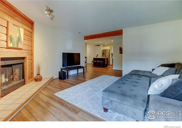 living area featuring a fireplace and wood finished floors