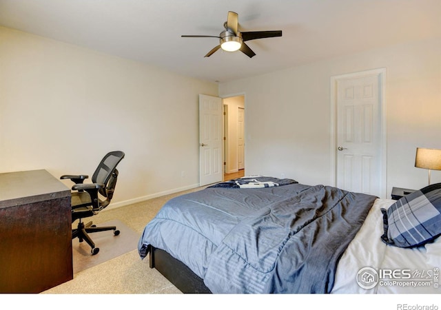 carpeted bedroom featuring ceiling fan and baseboards