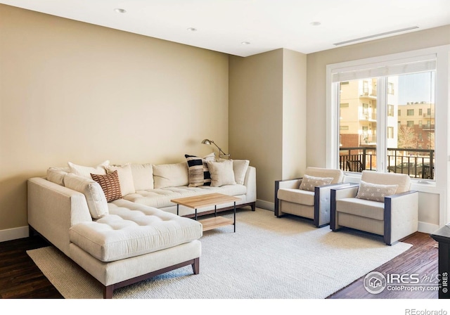 living room featuring wood finished floors and baseboards