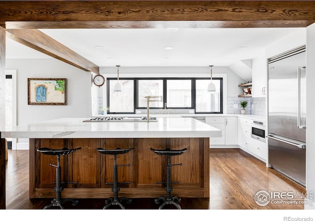 kitchen featuring light stone counters, open shelves, backsplash, appliances with stainless steel finishes, and white cabinets