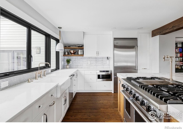 kitchen featuring tasteful backsplash, white cabinets, high end appliances, dark wood-style floors, and open shelves