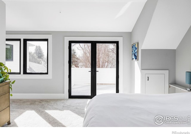 carpeted bedroom featuring vaulted ceiling, french doors, baseboards, and access to exterior