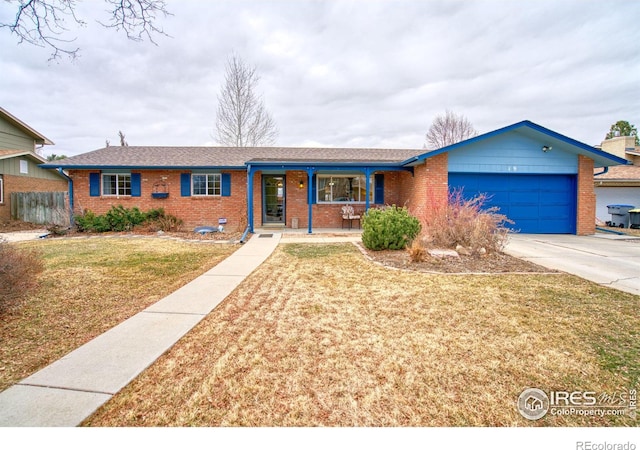 single story home featuring a garage, brick siding, fence, a porch, and a front yard