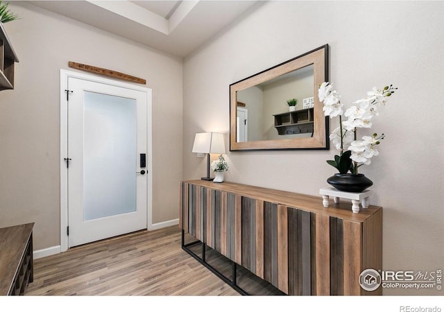 entryway featuring wood finished floors and baseboards