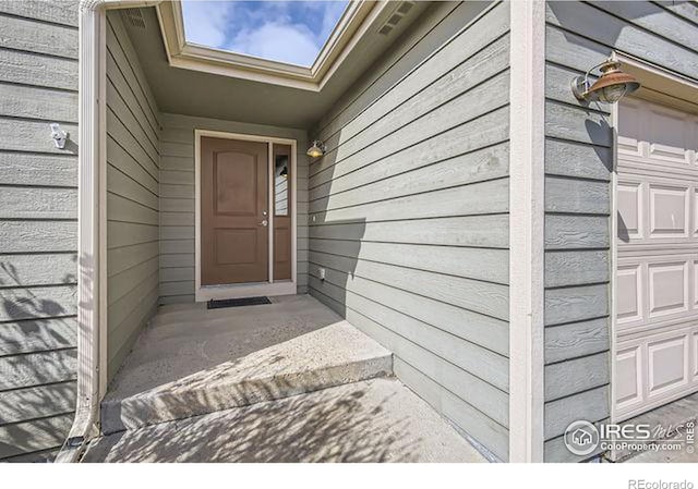 property entrance with a garage