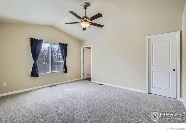 spare room with baseboards, lofted ceiling, a ceiling fan, and carpet flooring