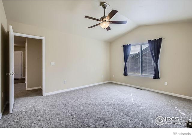 empty room featuring baseboards, lofted ceiling, carpet, and a ceiling fan