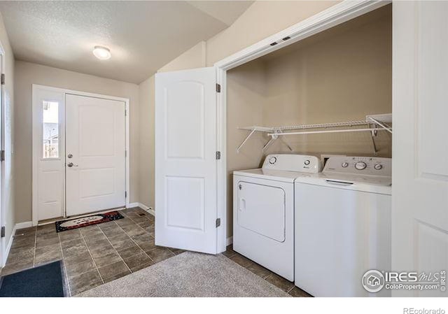 washroom with tile patterned flooring, laundry area, baseboards, and washer and clothes dryer