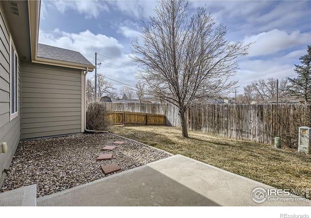 view of yard featuring a patio and fence