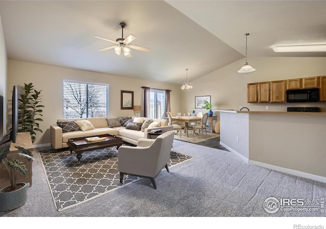 living area featuring baseboards, a ceiling fan, dark carpet, and vaulted ceiling