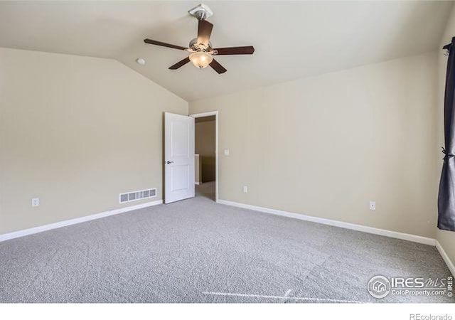 empty room featuring visible vents, a ceiling fan, baseboards, carpet flooring, and lofted ceiling