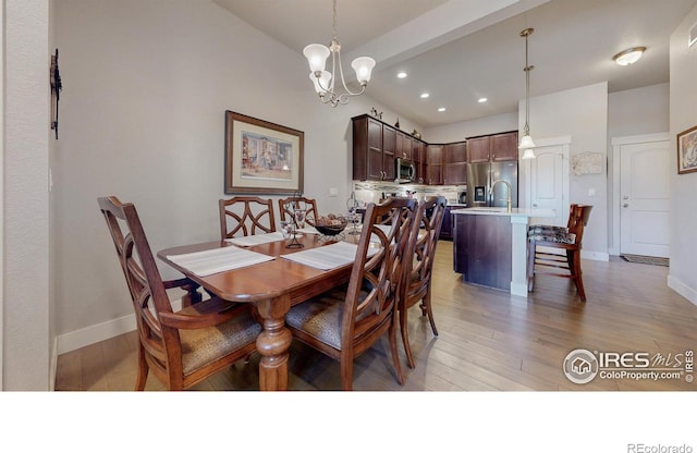 dining space featuring a chandelier, recessed lighting, light wood-style flooring, and baseboards