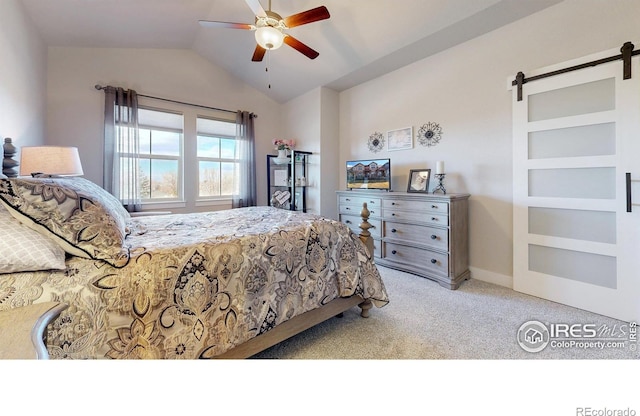 bedroom with a barn door, a ceiling fan, carpet flooring, vaulted ceiling, and baseboards