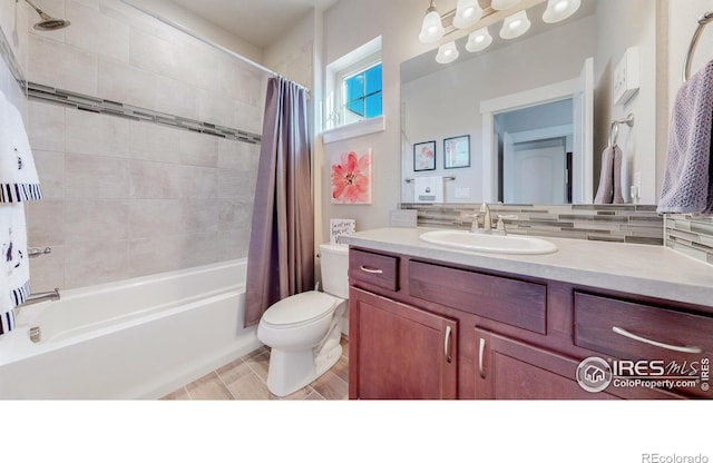 full bathroom featuring toilet, shower / bath combo, backsplash, and vanity