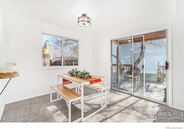 dining space with carpet flooring and baseboards