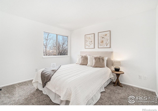 carpeted bedroom featuring baseboards