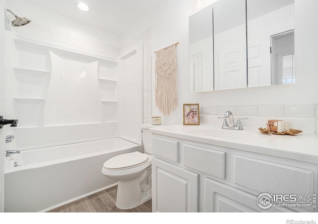 full bathroom with vanity, shower / bathing tub combination, wood finished floors, and toilet