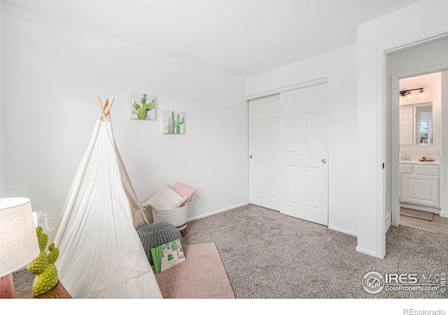 unfurnished bedroom featuring carpet floors, baseboards, and a closet