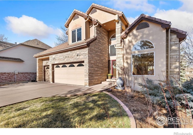 view of front of home with stone siding, concrete driveway, and stucco siding