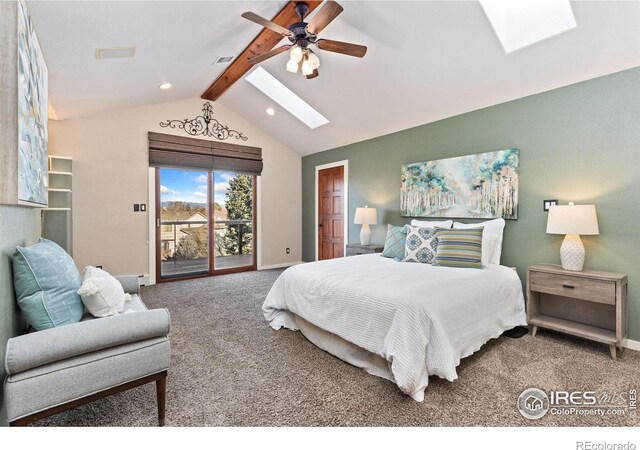 carpeted bedroom featuring access to outside, lofted ceiling with skylight, visible vents, and baseboards