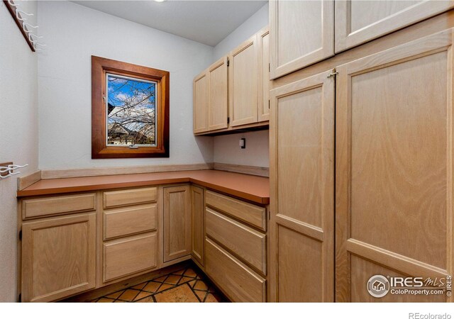 kitchen featuring light brown cabinetry and light countertops