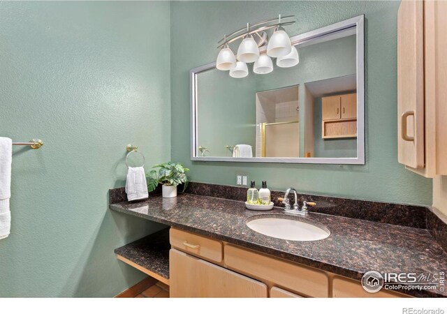 full bathroom featuring a shower stall and vanity