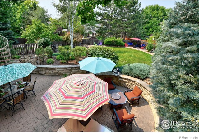 view of patio featuring outdoor dining space, outdoor lounge area, and fence