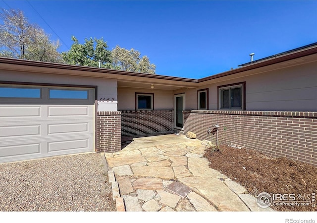 view of front of home with an attached garage and brick siding