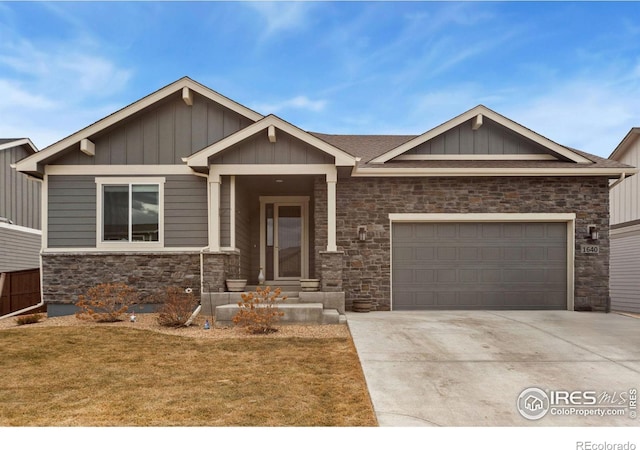 craftsman-style house featuring a garage, a front yard, concrete driveway, and board and batten siding