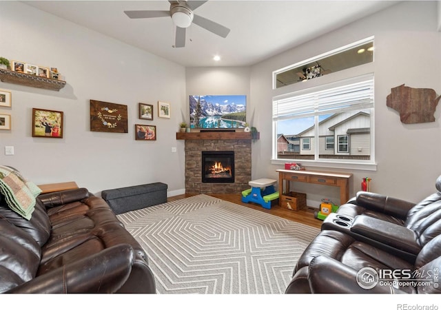 living room with a fireplace, recessed lighting, ceiling fan, wood finished floors, and baseboards