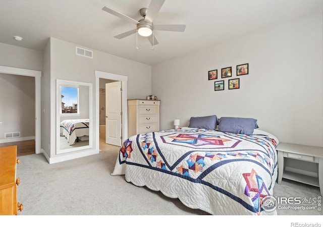 carpeted bedroom with a ceiling fan, visible vents, and baseboards