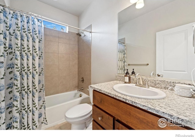 bathroom featuring toilet, shower / bath combo with shower curtain, vanity, and tile patterned floors