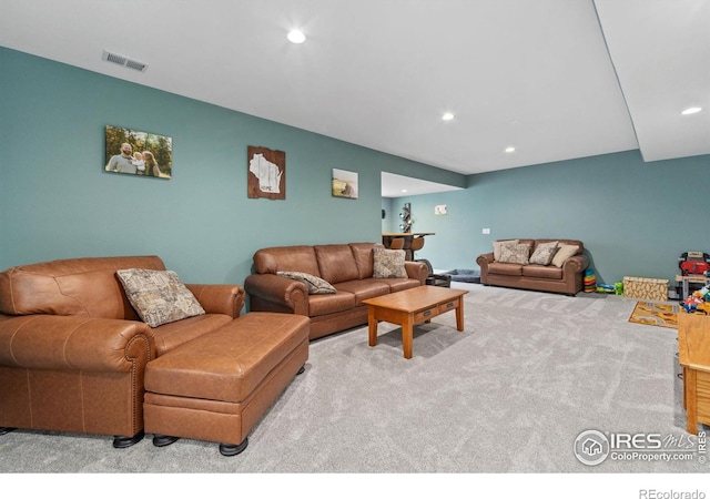 carpeted living room featuring visible vents and recessed lighting