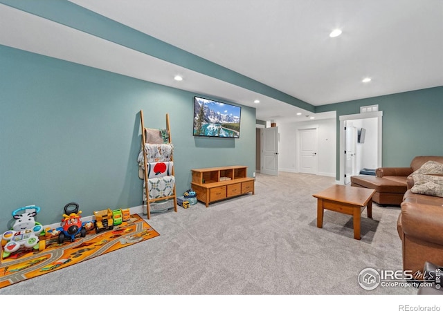 living area with carpet, baseboards, and recessed lighting