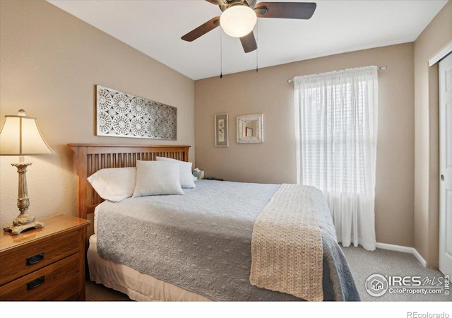 carpeted bedroom featuring ceiling fan and baseboards