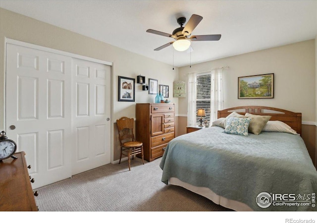 carpeted bedroom with a ceiling fan and a closet