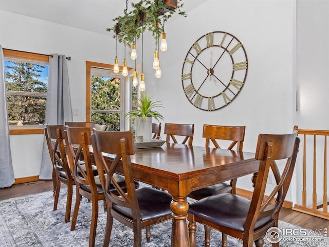 dining area featuring wood finished floors and baseboards