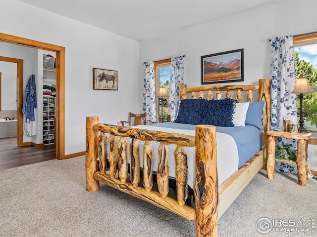 carpeted bedroom with baseboards