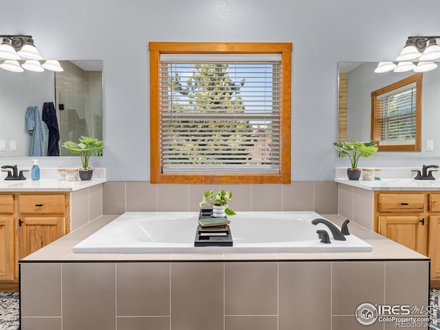 bathroom featuring a garden tub and vanity