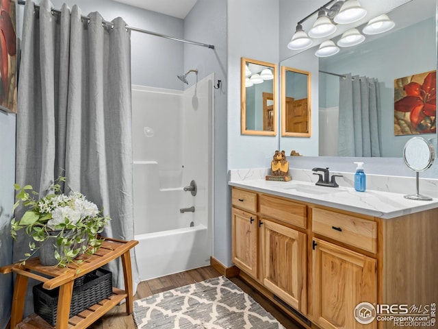 bathroom featuring shower / tub combo, wood finished floors, and vanity