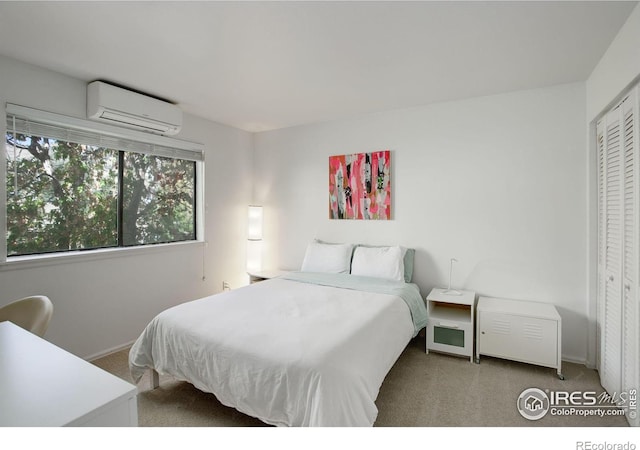 carpeted bedroom featuring a closet and a wall mounted air conditioner