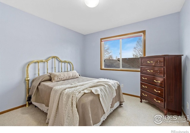 bedroom featuring baseboards and light colored carpet