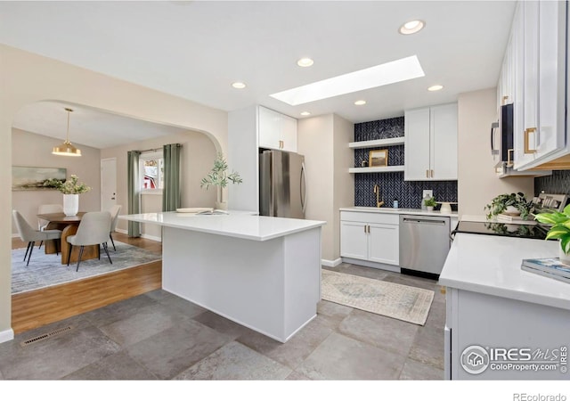 kitchen featuring open shelves, appliances with stainless steel finishes, light countertops, and white cabinets