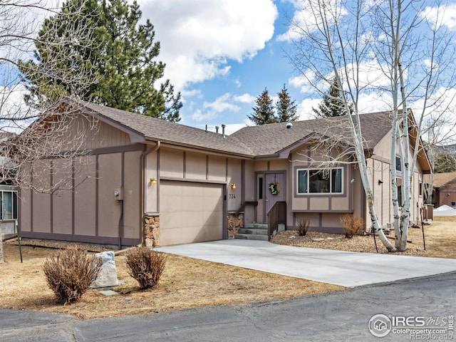 view of front of house featuring driveway, roof with shingles, an attached garage, and board and batten siding