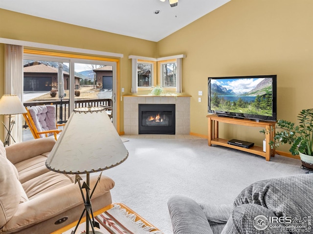 living area featuring lofted ceiling, carpet, a fireplace, and baseboards