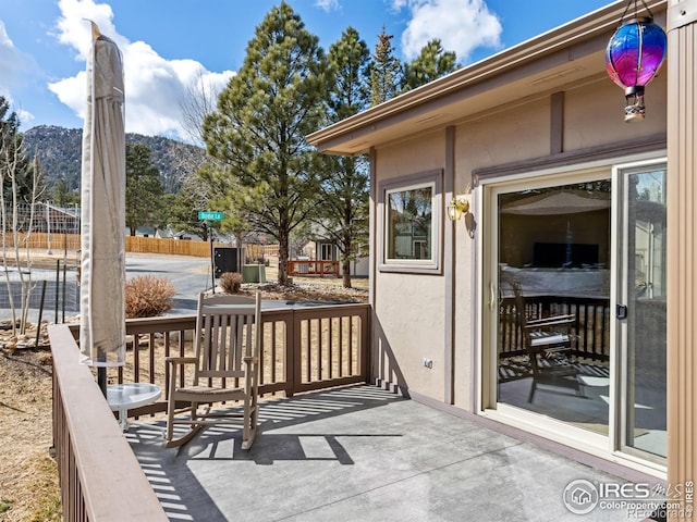 wooden deck with fence and a mountain view