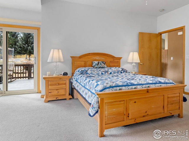 bedroom with access to outside and carpet floors