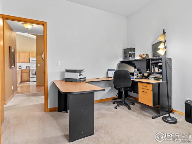 home office with light carpet and baseboards