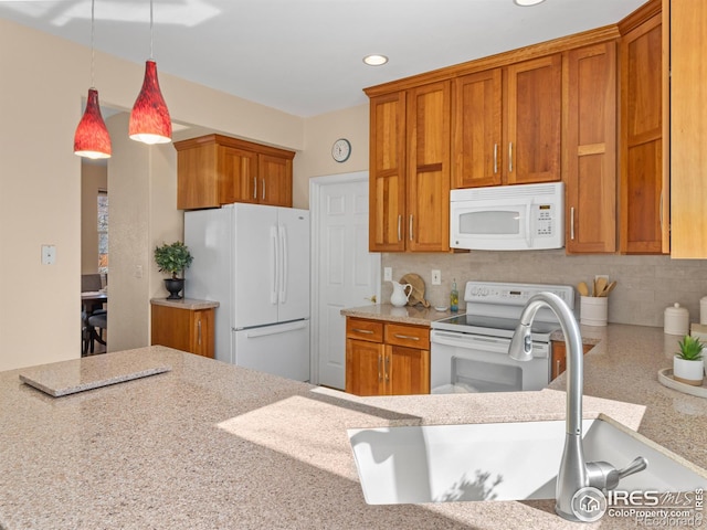 kitchen featuring white appliances, brown cabinetry, and tasteful backsplash